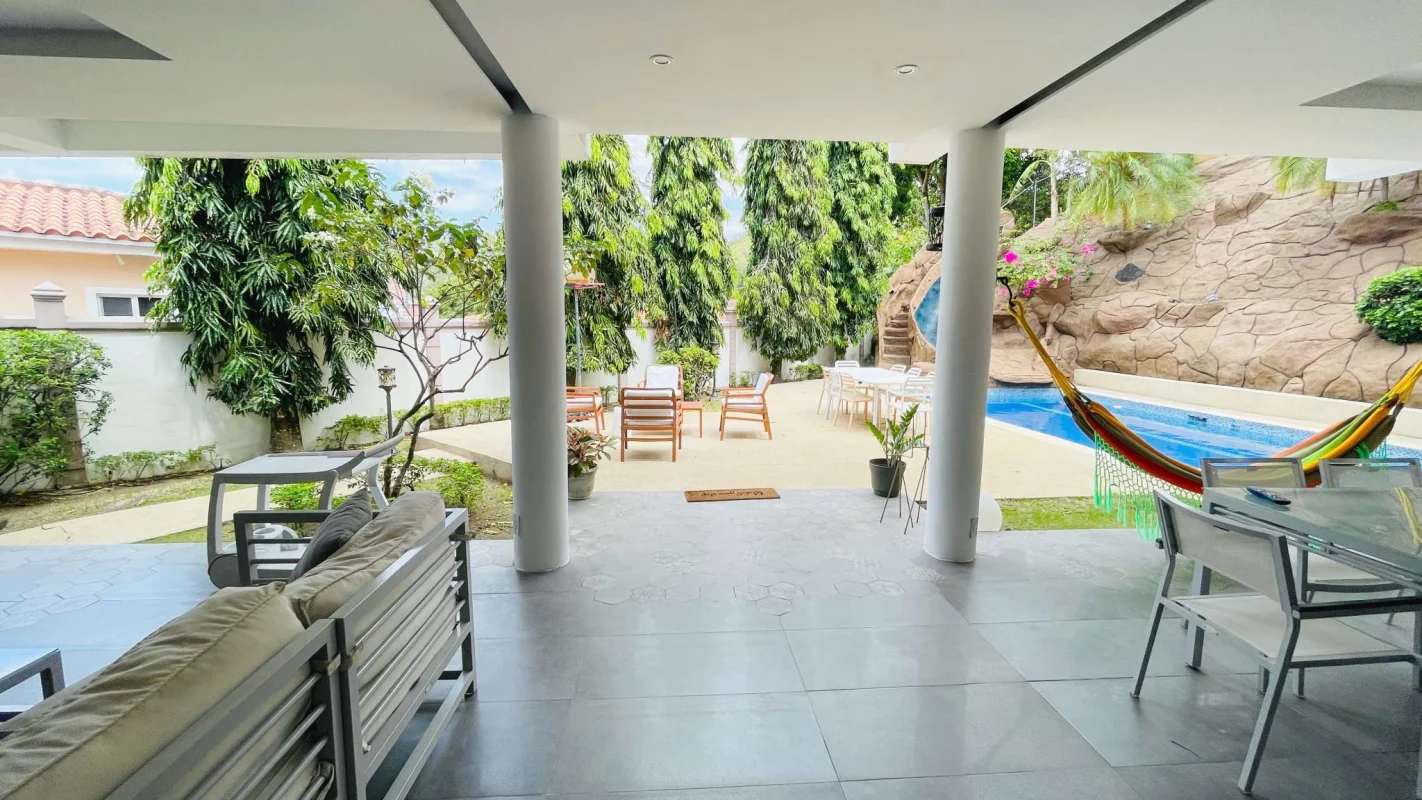 Covered terrace facing private pool with waterfall and slide in PH Torres de Toscana Condado del Rey Panama