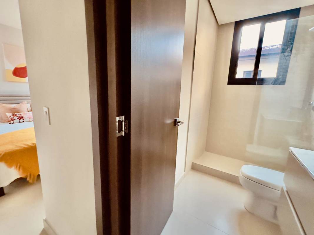 Open mezzanine loft overlooking living room in duplex condo PH Casa Bianca Costa del Este