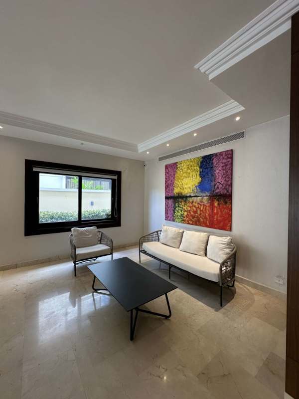 Spacious living area with marble floors large windows and modern lighting in luxury Costa del Este rental house