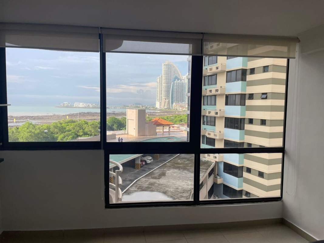 Modern bedroom with large windows, city and ocean views in PH San Francisco Bay Panama City