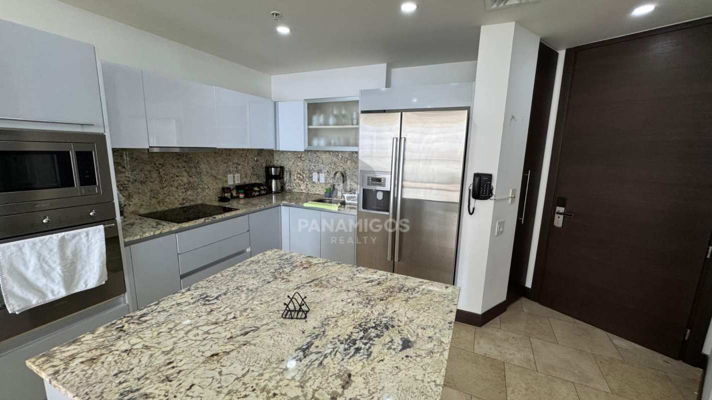 Contemporary kitchen with stainless steel appliances and granite countertops in luxury condo Punta Pacífica