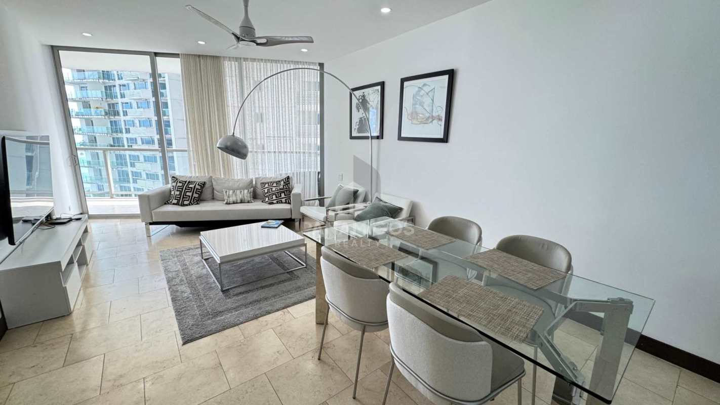 Dining area adjacent to kitchen with granite counters in apartment The Ocean Club Panama