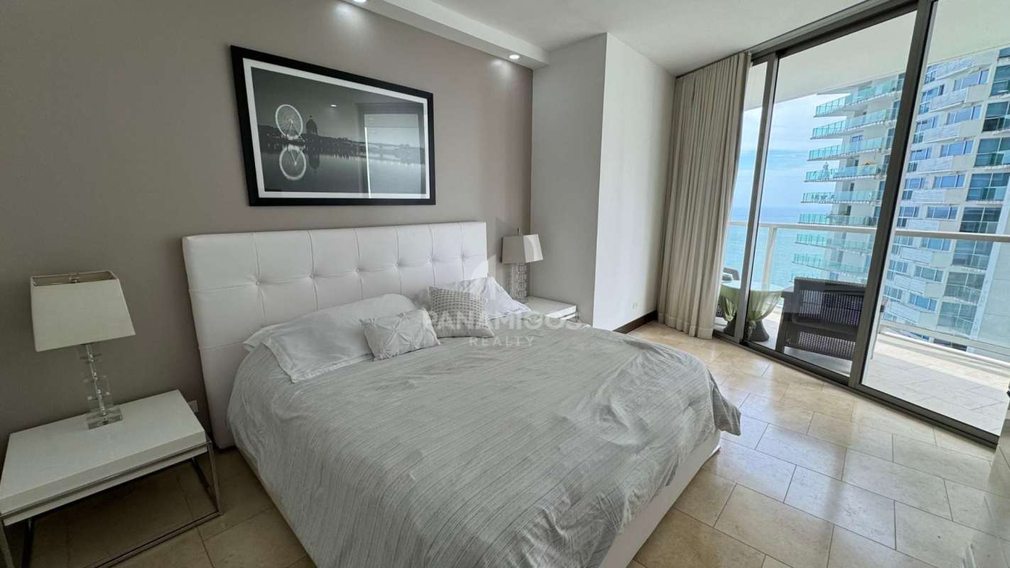 Modern living room with dining area and balcony access in The Ocean Club Punta Pacífica