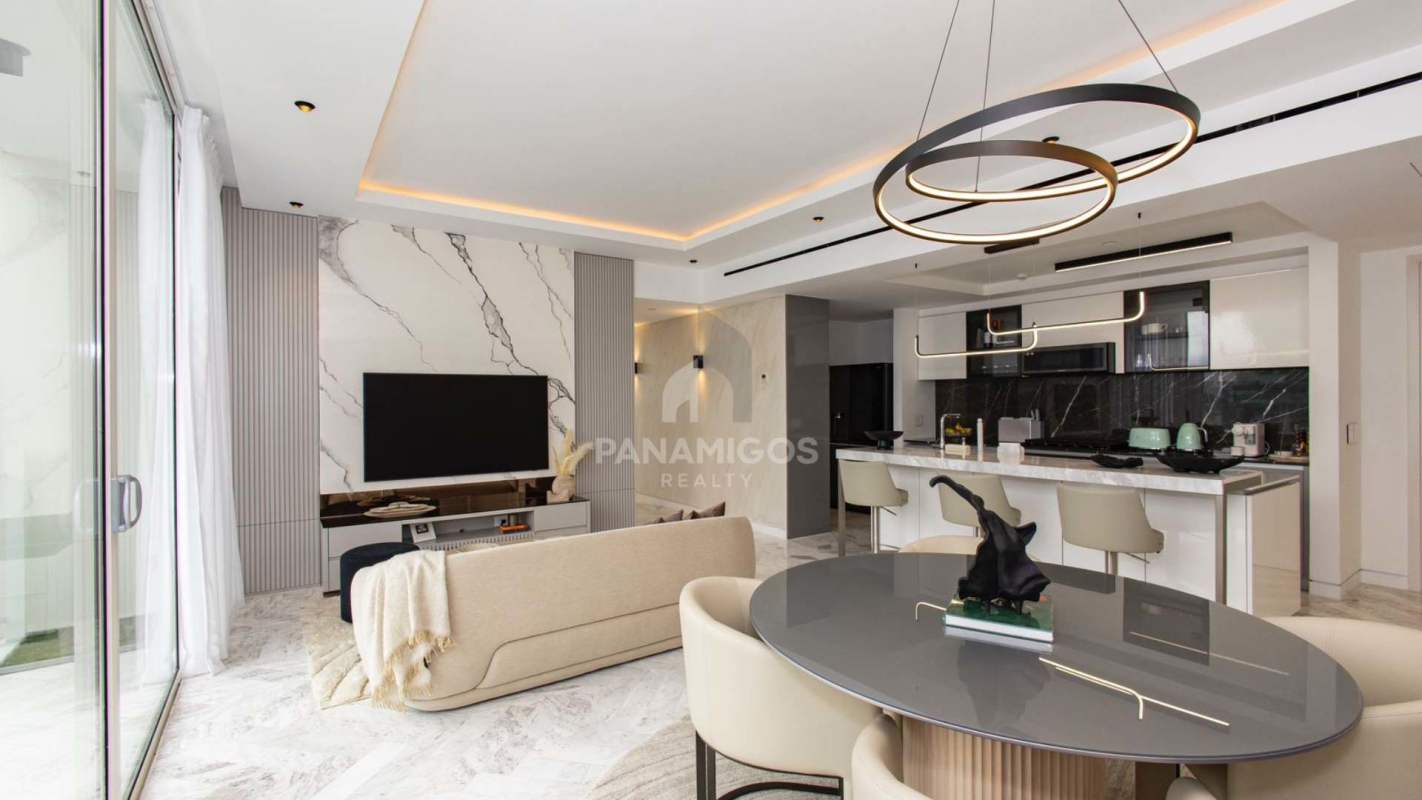 Open-plan lounge area with curved sofa and city skyline Wanders & Yoo Panama City