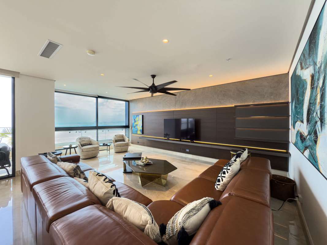 Large primary bedroom with panoramic floor-to-ceiling windows overlooking ocean and Panama skyline in PH Matisse Costa del Este