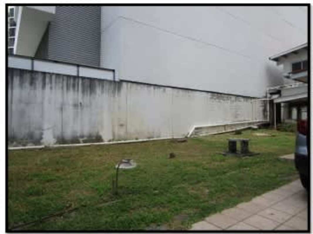 Lawn with concrete wall, spacious open outdoor area at Panama City redevelopment property