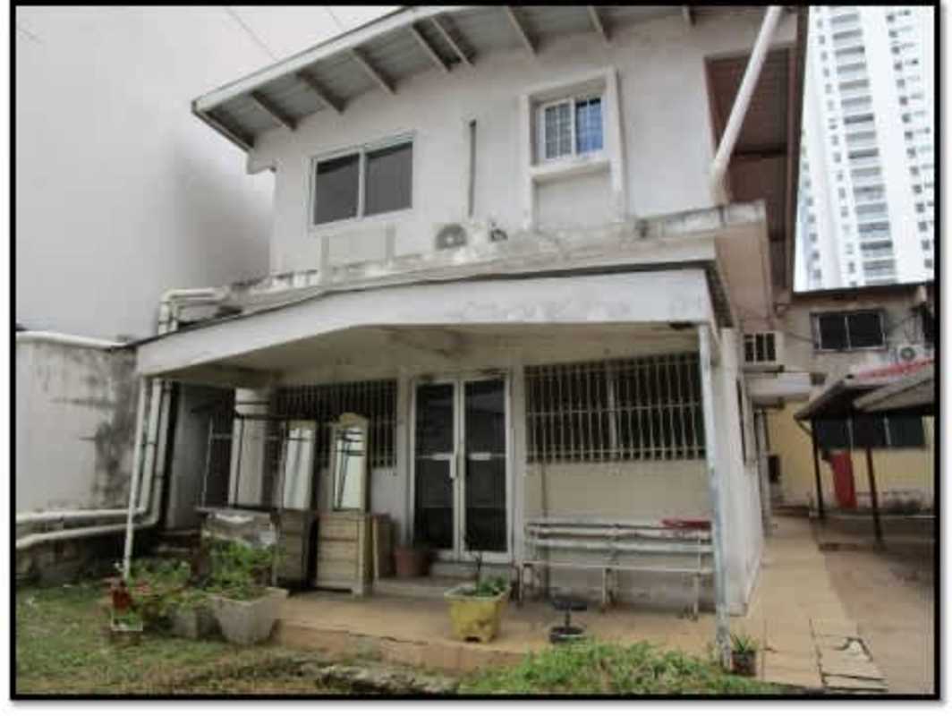 Single story home, garden, urban backdrop at investment site in San Francisco Panama