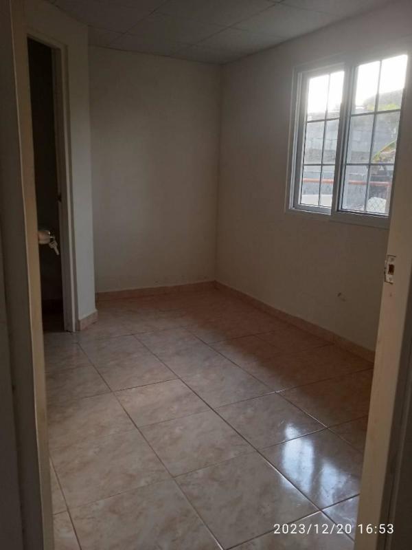 Empty bedroom with window and small bathroom at Tatare Pacora affordable rental Panama