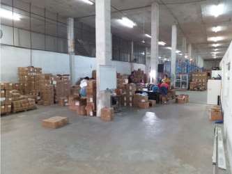 Industrial warehouse interior with racks and open storage Colón Panama