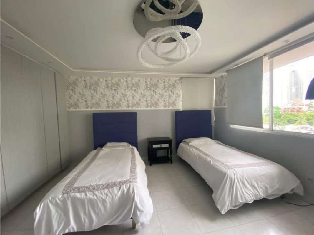 Contemporary bedroom with twin beds, large window, chandelier in PH Ritz Punta Paitilla