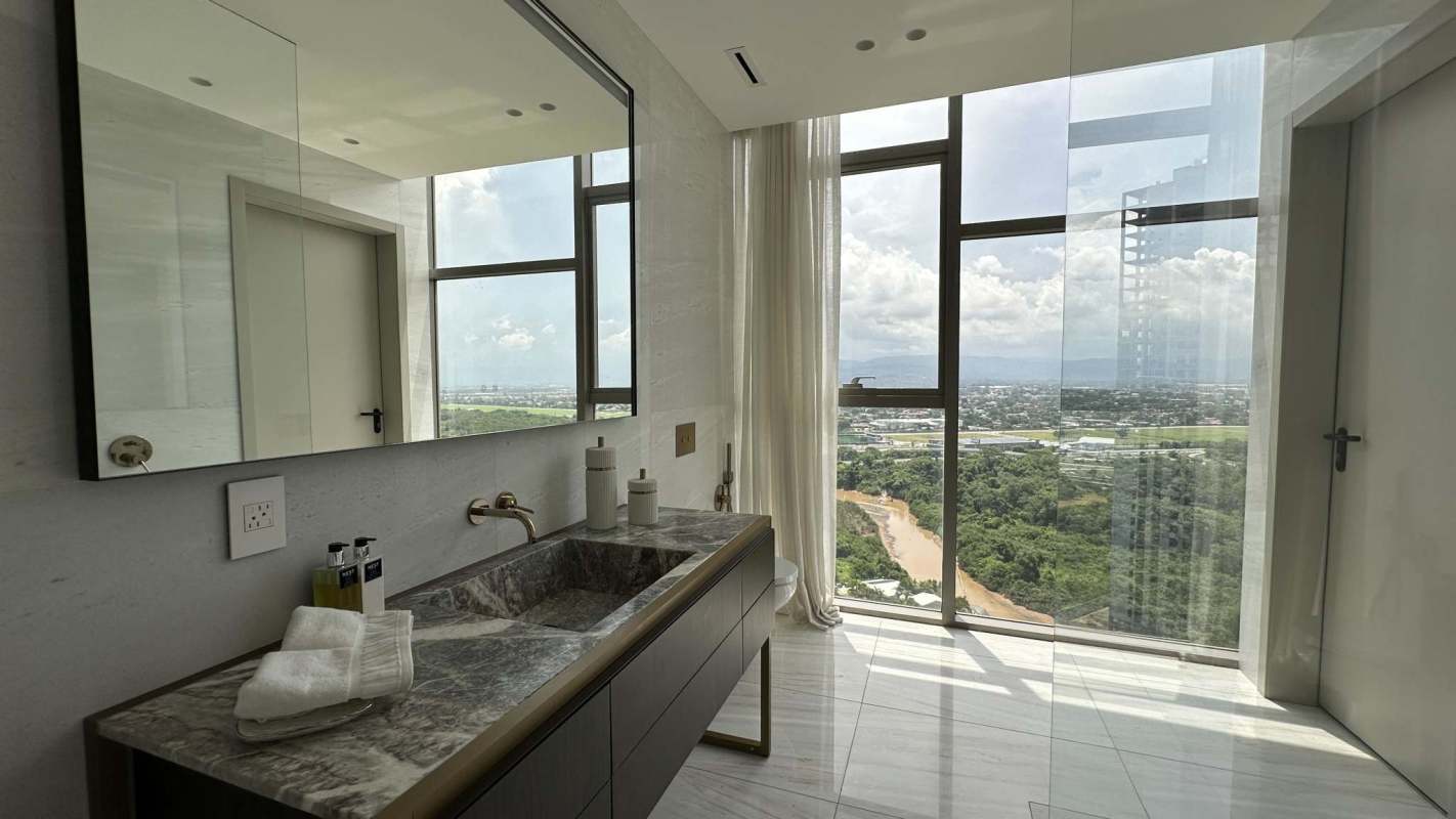 Minimalist bathroom with freestanding tub and panoramic window in PH Fendi Casa Tower Santa Maria Panama City