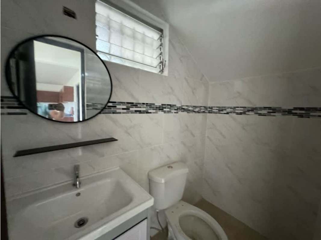 Contemporary bathroom with double sinks, glass shower enclosure, and large windows in corner rental house El Dorado Panama