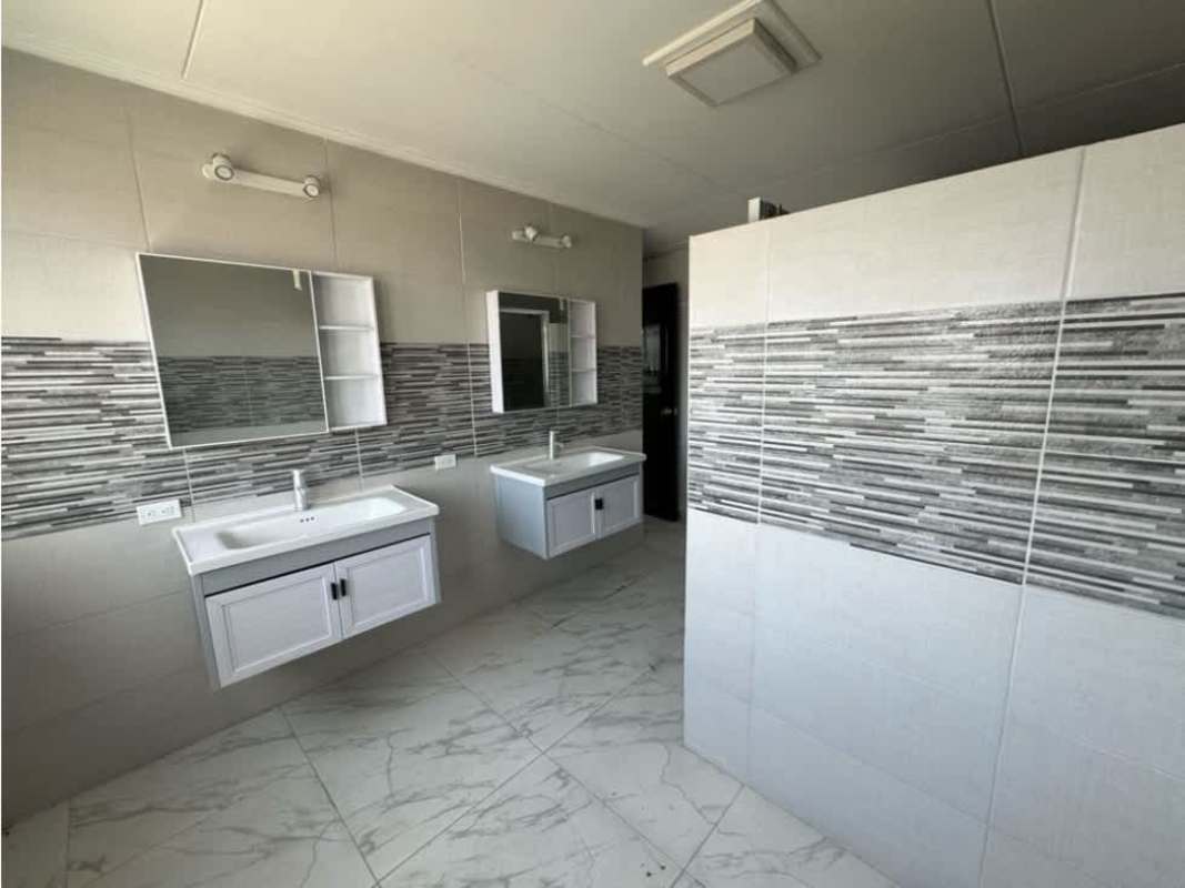 Modern bathroom with glass shower enclosure tile walls and pedestal sink corner house Bethania for rent