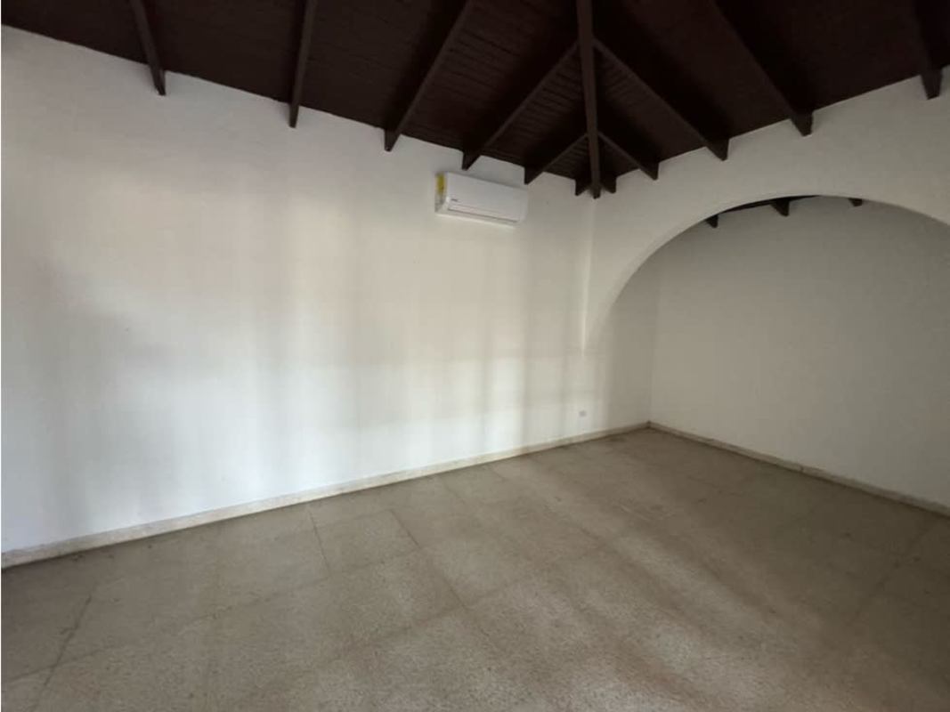 Large open plan living room with tiled floor wood ceiling beams and arches in Mediterranean style home Bethania Panama