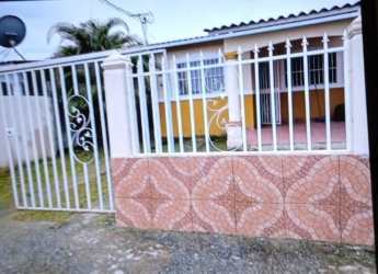 Front facade of house with security fence, tiled porch, and garden in Valle Hermoso Nuevo Arraiján Panama