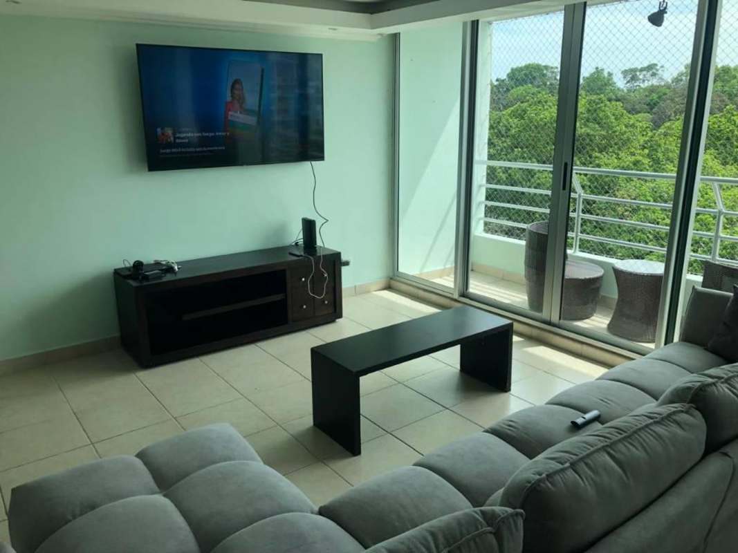 Spacious master bedroom furnished with TV, AC, large windows in Panama apartment for rent Clayton Park