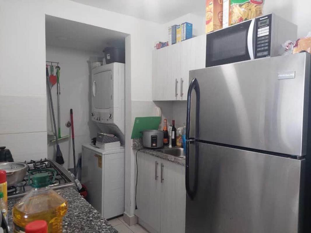 Cozy bedroom with city views and ceramic tile floors in PH Riverside Vía España apartment for sale