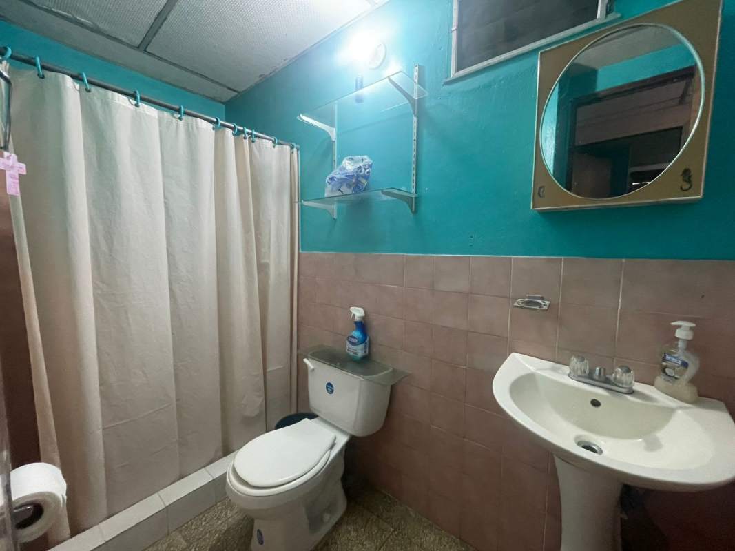 Bedroom with closet, window, ceiling fan and simple finishes in Villa Lucre home