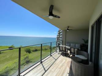 Private balcony with glass railings overlooking Pacific Ocean at PH Solaria San Carlos Panama