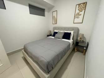 Master suite with large windows, balcony ocean view at PH Solaria Punta Caelo Panama