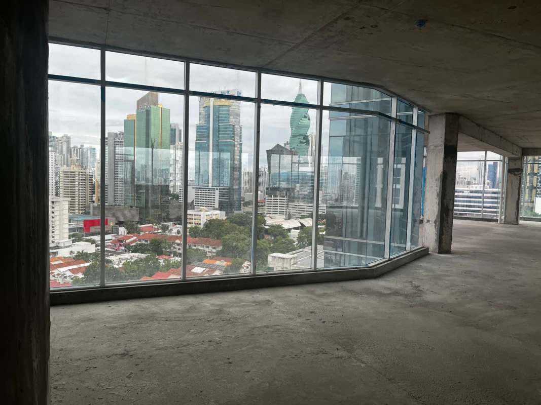 Panama skyline seen through floor-to-ceiling windows of commercial shell space for sale Obarrio District