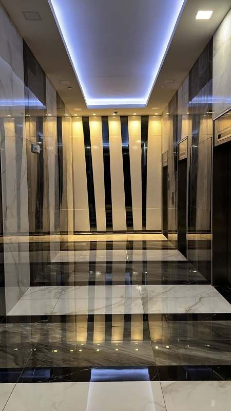 Elevator lobby with marble floors and modern panel walls inside PH Financial Park Tower Obarrio Panama
