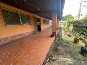 Spacious living room with ceramic floors and large windows in Capira house