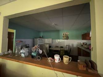Traditional kitchen with serving window and tiled counters rural house