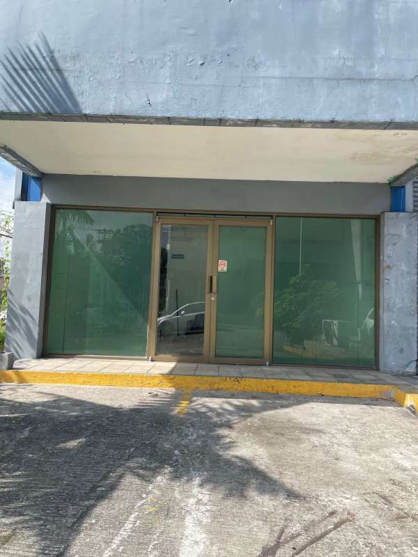 Glass facade commercial retail storefront with parking access on Avenida Balboa Panama City