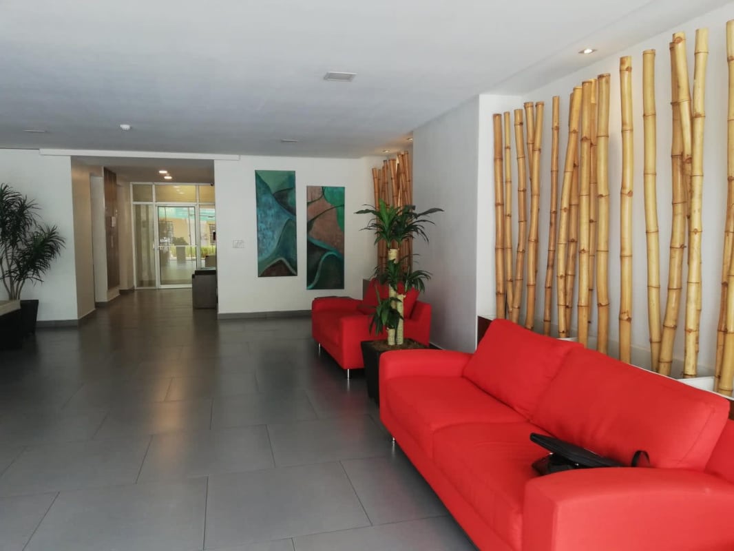 Lobby entrance with glass doors and reception in PH San Francisco 67 Panama City