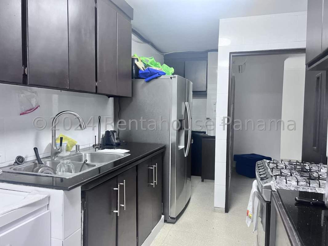 Functional kitchen space with cabinets stove and ceramic flooring in PH Aida San Francisco Panama