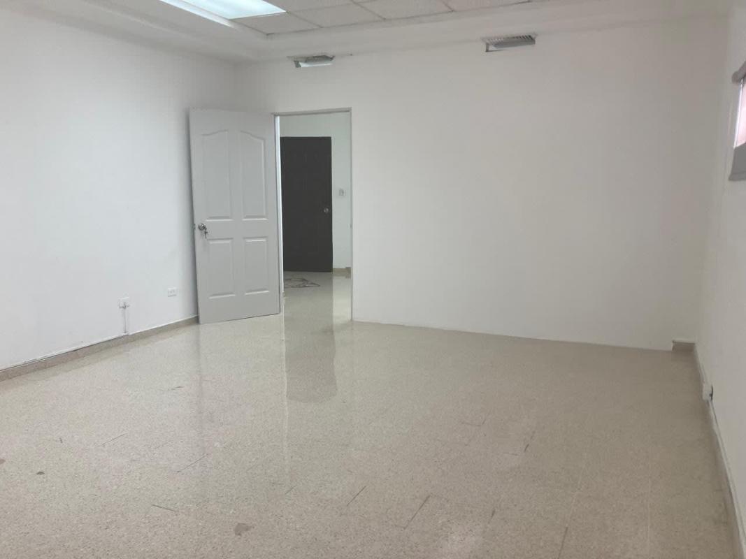 Empty white-walled office room with tiled floor and ceiling lights near Via Argentina Station