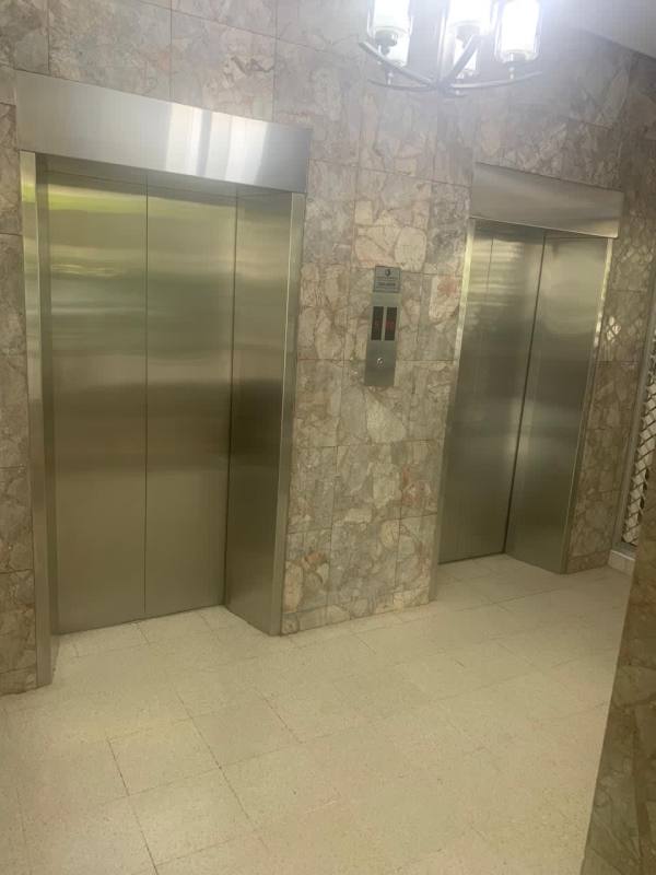 Exterior view of multi-story PH Marina Plaza with balconies and parking