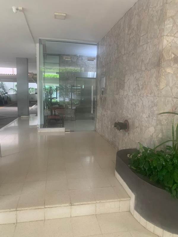 Modern lobby entrance with marble walls and planters PH Marina Plaza