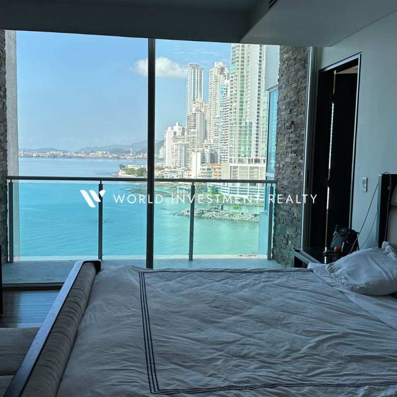 Marble-clad modern double-height lobby of PH Aquamare with reception and seating area in Punta Pacifica Panama