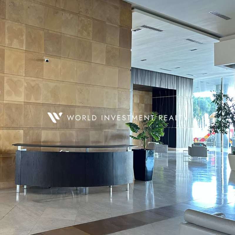 Spacious living room area with large windows and balcony overlooking Pacific Ocean at PH Aquamare in Panama City