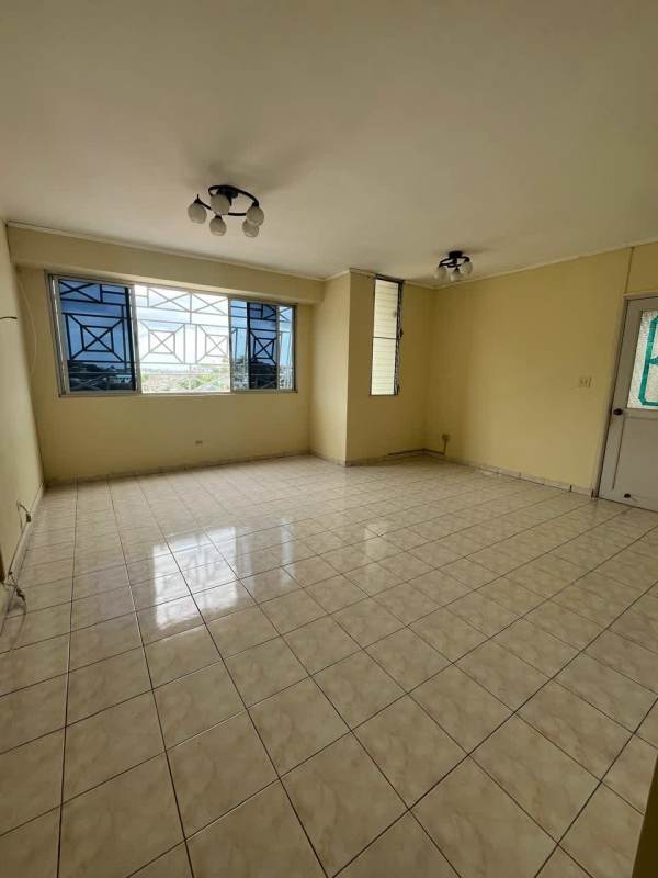 Bright tiled living and dining area with large windows at PH Las Roccas near Tumba Muerto Panama