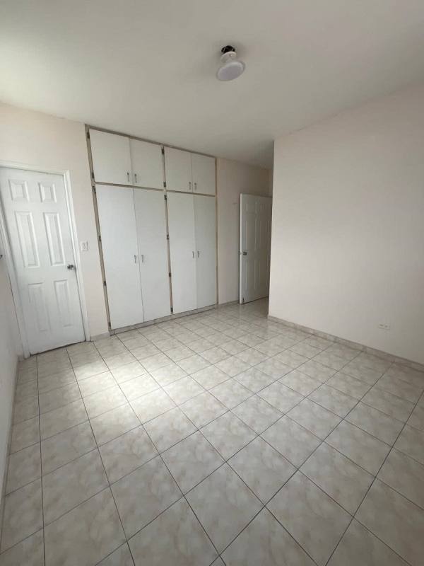 Second bedroom with closet and ceramic tile floors at PH Las Roccas Panama City
