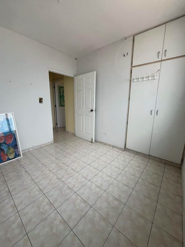Unfurnished bedroom with built-in wardrobe and tiled floors at PH Las Roccas Panama City