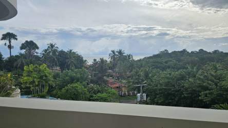 Balcony overlooking tropical gardens and glimpses of Pacific Ocean at Mirador Las Lajas Coronado