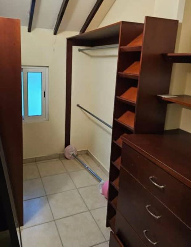 Kitchen with wooden cabinets, stainless fridge, granite countertops in house for sale PH Torres de Toscana Clayton Albrook