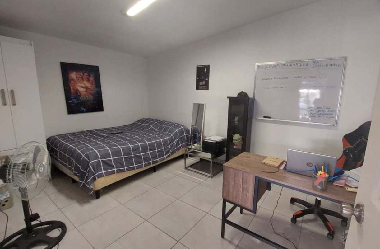 Kitchen with wood cabinetry stainless appliances dining space PH Torres de Toscana Panama
