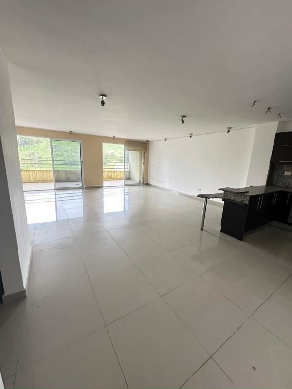 Resort-style outdoor pool with mountain background and landscaped gardens in PH Altamira Gardens Panama