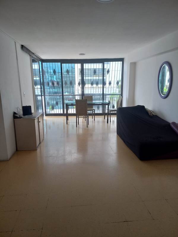 Minimalist living dining room large windows tile floor furniture metro nearby Obarrio Panama.
