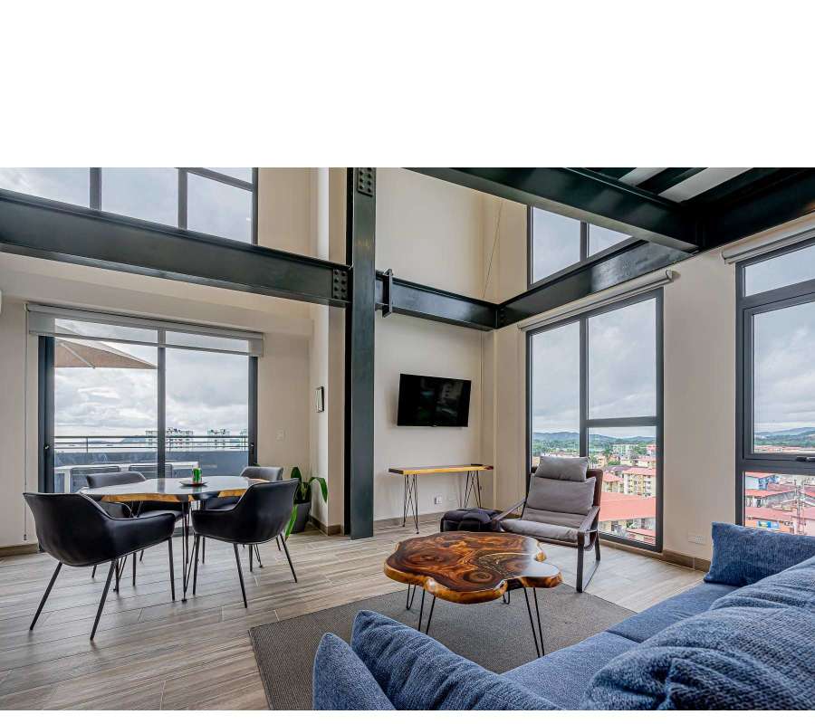 Sleek contemporary kitchen with green tile and stainless appliances at PH Casco View Casco Viejo