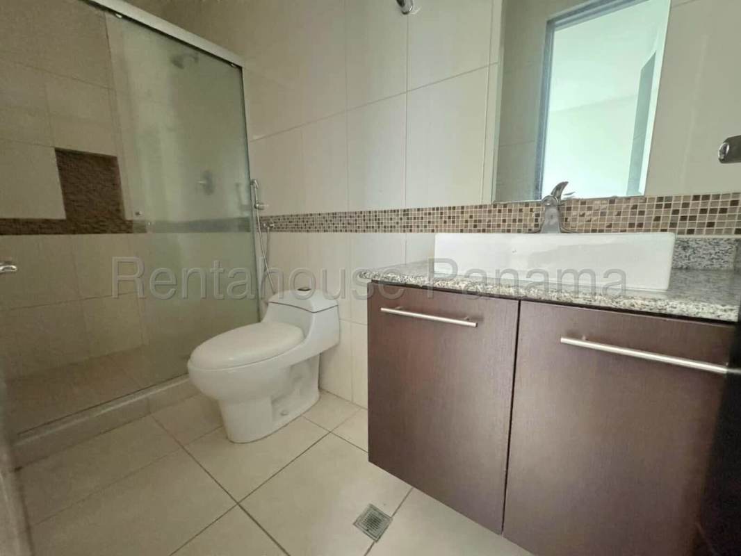 Bathroom with glass shower enclosure, granite countertops, and mosaic walls at PH Edison Park Tower Panama