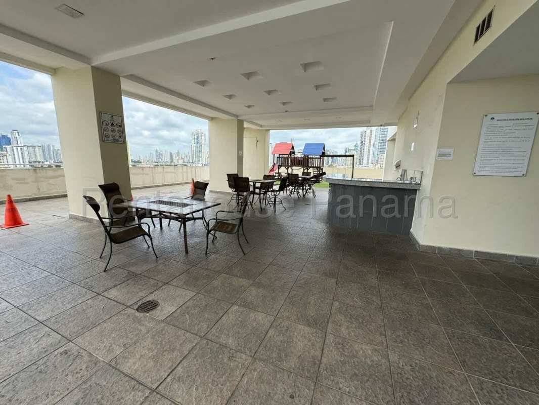 Communal terrace area with playground and city views at PH Edison Park Tower Panama