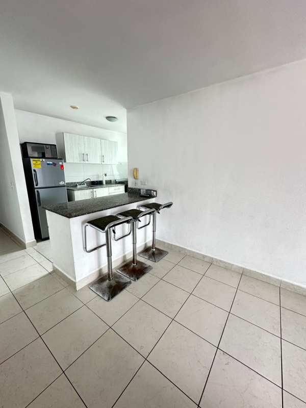 Open concept kitchen and dining with granite bar in PH Riverside Parque Lefevre Panama City