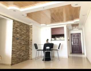 Modern dining with glass table, stone accent wall, recessed lights PH Silver City Portobelo Panama