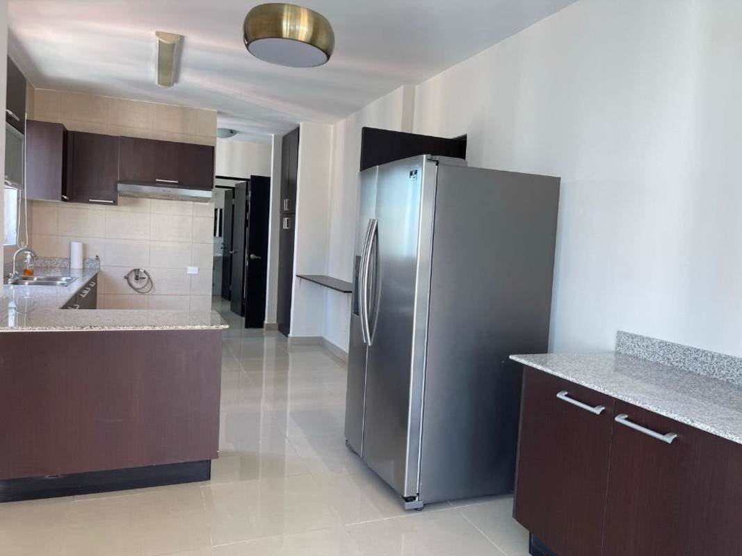 Kitchen with granite counters, stainless fridge and appliances in PH Vista del Mar Panama